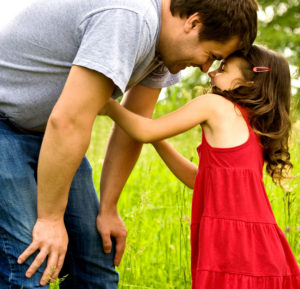 Father leaning down to daughter - Real Life Heroes