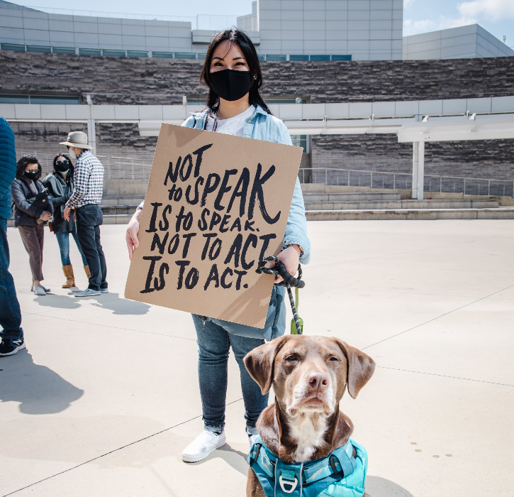 Young woman holding anti-racist sign