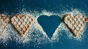 Waffles in the shape of hearts with sugar sprinkled on top